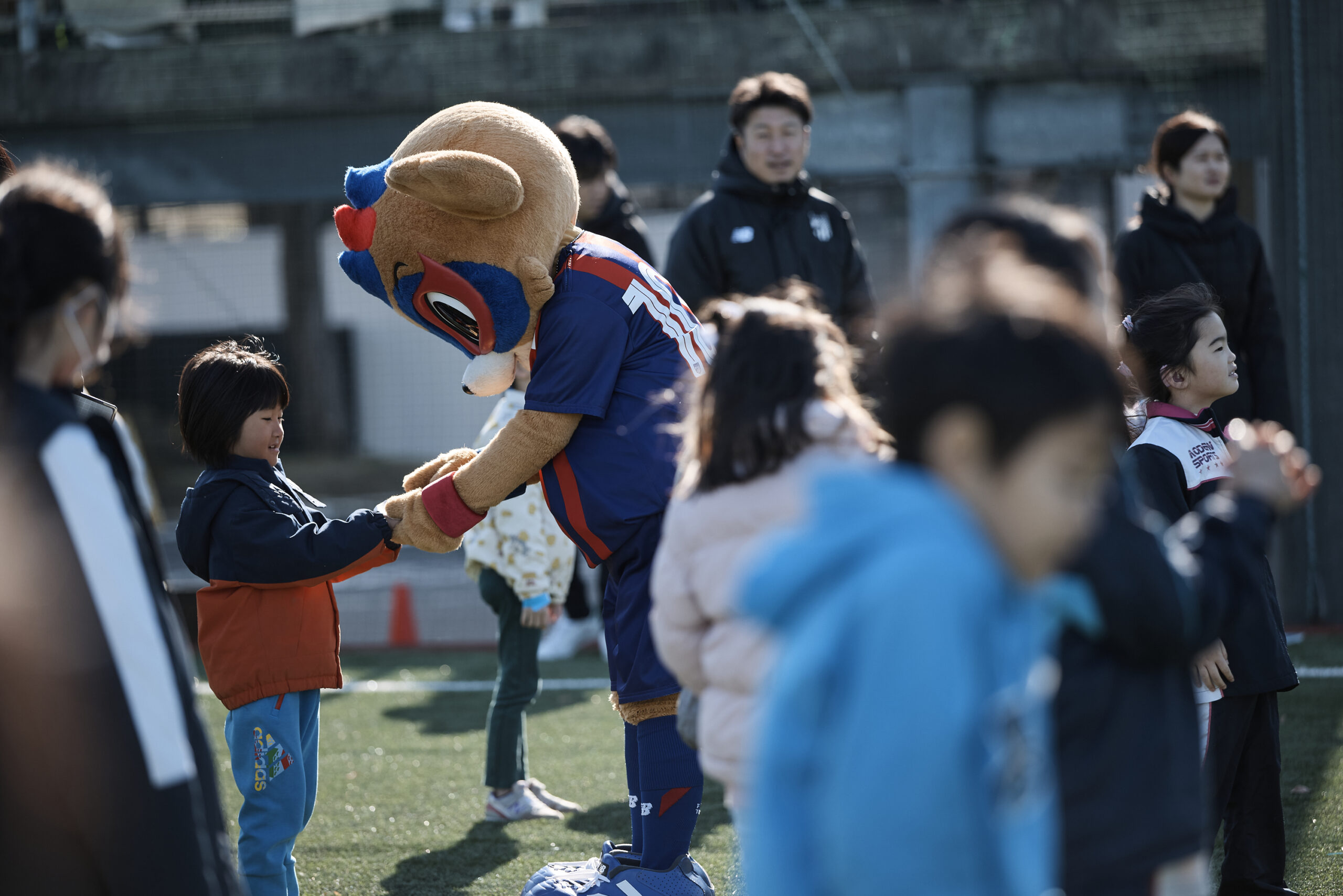 参加者の女の子の手を握っている東京ドロンパの写真