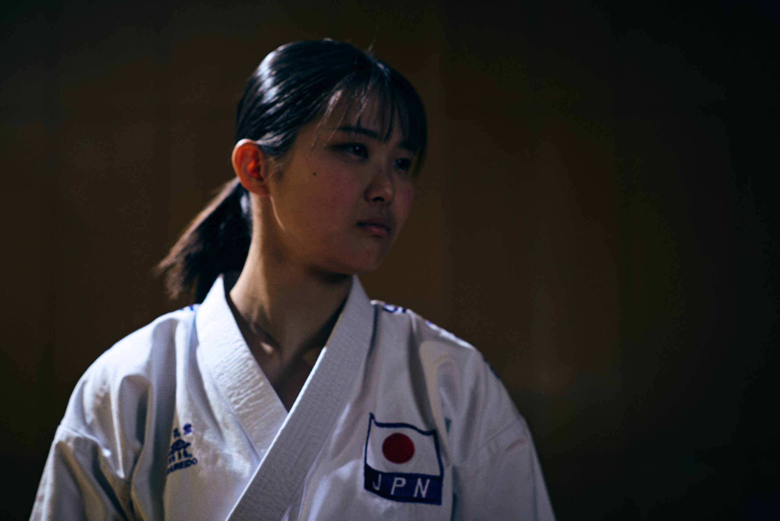 The photo of Ogura in her karate uniform, staring left.